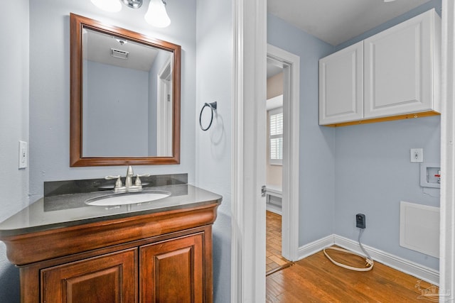 bathroom with vanity and wood-type flooring