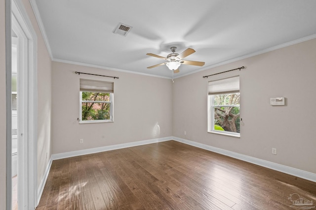 unfurnished room featuring ornamental molding, dark wood-type flooring, a wealth of natural light, and ceiling fan