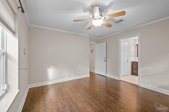 unfurnished bedroom with wood-type flooring, ornamental molding, and ensuite bathroom