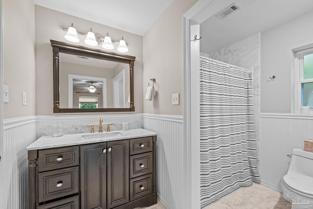 bathroom with ceiling fan, vanity, toilet, and a shower with shower curtain