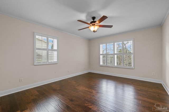 spare room featuring dark wood-type flooring, ceiling fan, and crown molding