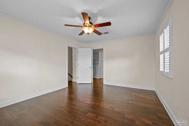 spare room featuring ornamental molding, dark wood-type flooring, and ceiling fan