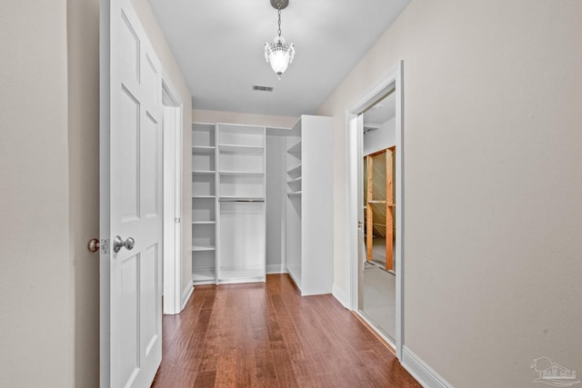 spacious closet with dark hardwood / wood-style floors