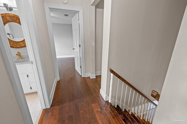 hall with dark wood-type flooring and sink