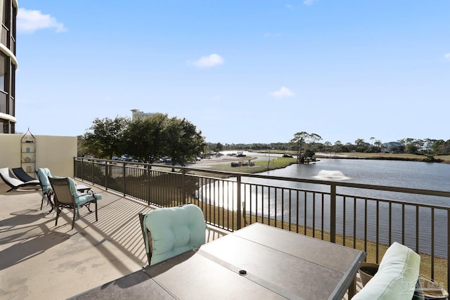 view of patio featuring a water view, outdoor lounge area, and a balcony