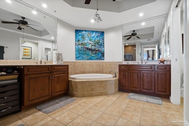 bathroom with a raised ceiling, vanity, and tile patterned flooring