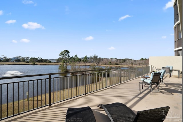 view of patio / terrace featuring a balcony and a water view