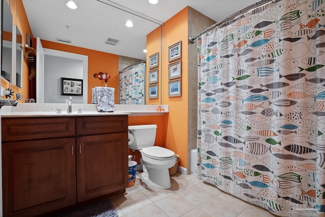 bathroom featuring toilet, tile patterned floors, and vanity