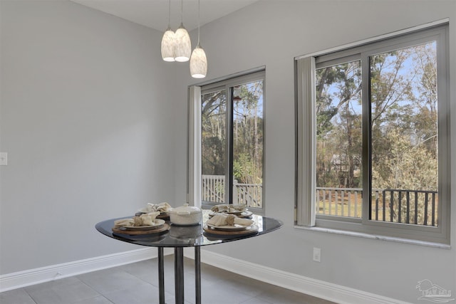 unfurnished dining area featuring tile patterned flooring