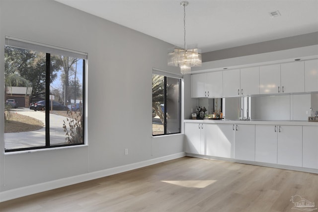 unfurnished dining area with light hardwood / wood-style floors