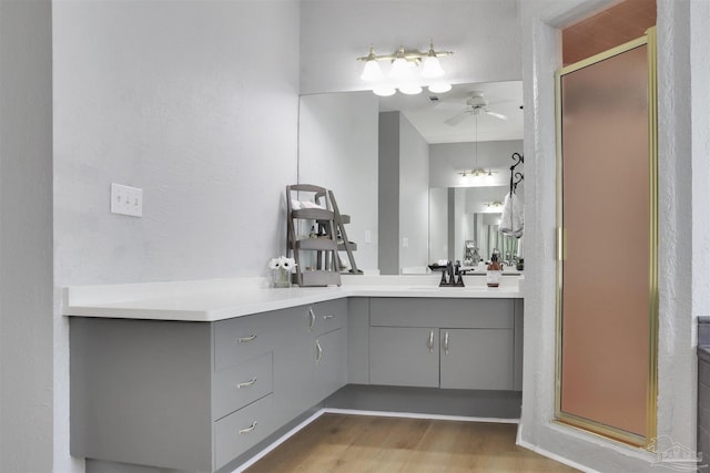 bathroom featuring vanity, an enclosed shower, wood-type flooring, and ceiling fan