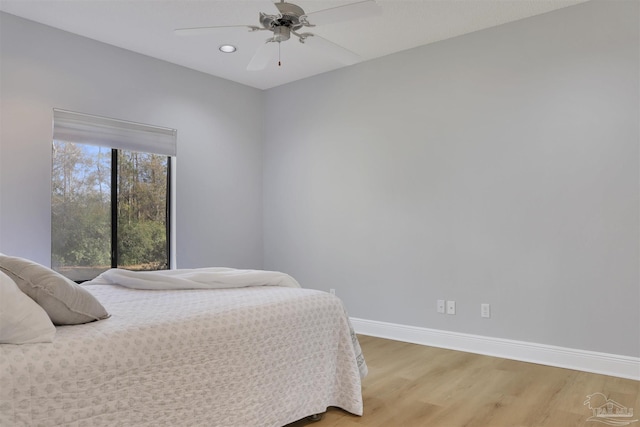 bedroom featuring ceiling fan and light hardwood / wood-style flooring