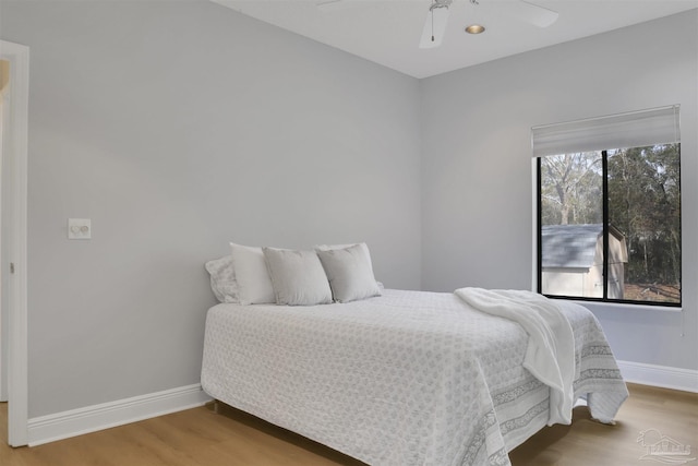 bedroom featuring hardwood / wood-style floors and ceiling fan