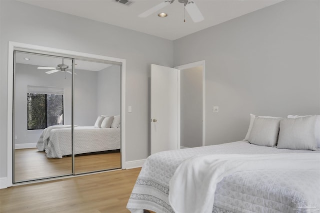 bedroom featuring hardwood / wood-style flooring, a closet, and ceiling fan