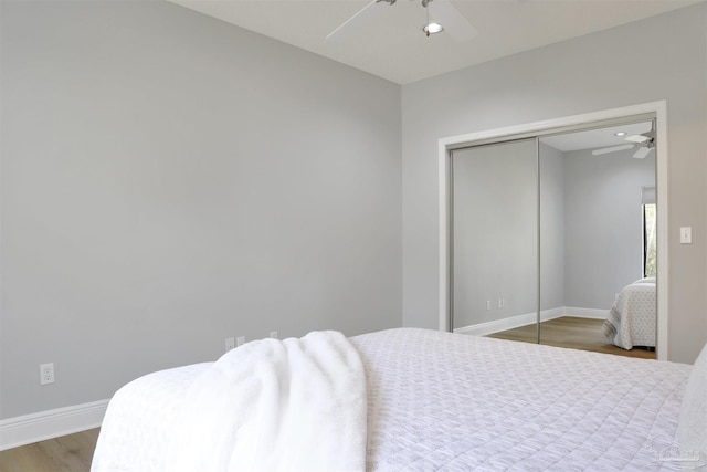 bedroom with hardwood / wood-style floors, ceiling fan, and a closet