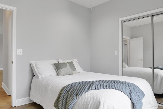 bedroom featuring hardwood / wood-style floors and a closet