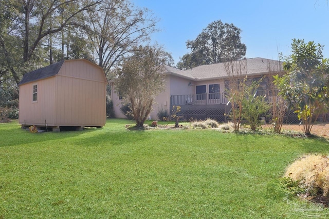 view of yard with a wooden deck and a storage unit