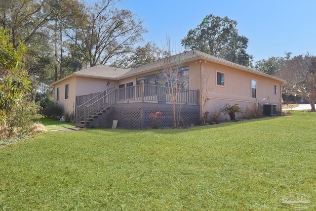 exterior space with central AC, a front yard, and a deck