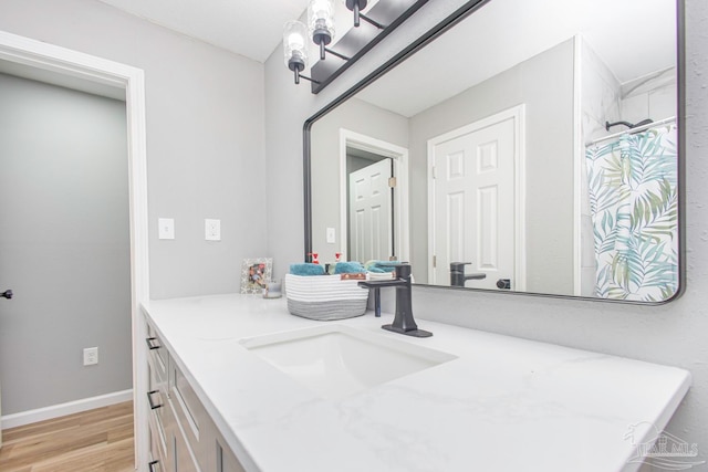 bathroom featuring hardwood / wood-style flooring and vanity