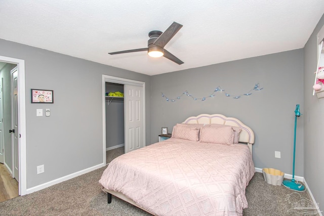 carpeted bedroom with ceiling fan and a closet