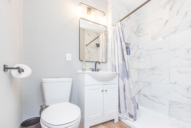 bathroom with a shower with curtain, vanity, toilet, and hardwood / wood-style floors