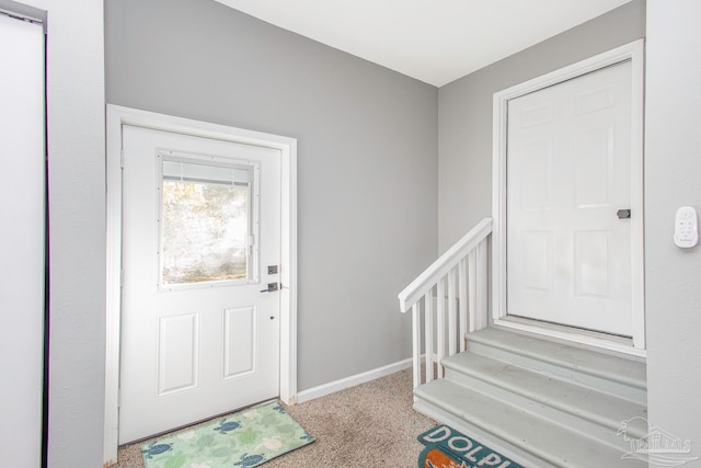 entrance foyer with carpet flooring