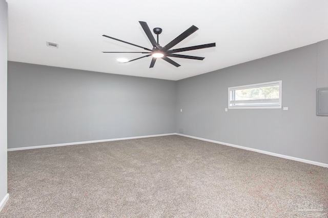 spare room with carpet flooring, ceiling fan, and electric panel