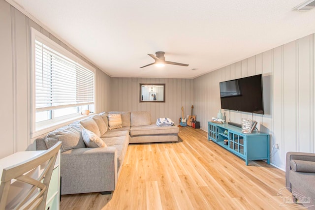 living room with hardwood / wood-style floors and ceiling fan