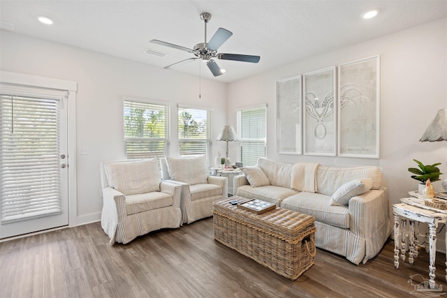 living room featuring hardwood / wood-style flooring and ceiling fan