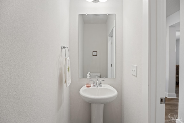 bathroom with hardwood / wood-style floors and toilet