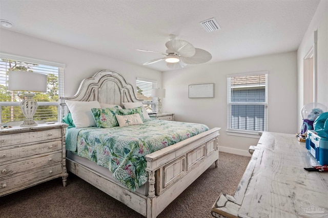 bedroom featuring dark colored carpet and ceiling fan