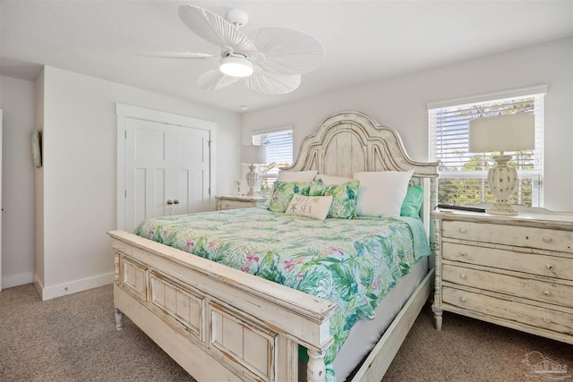 bedroom featuring multiple windows, ceiling fan, and carpet