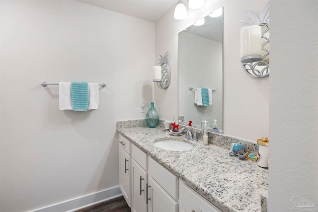 bathroom with hardwood / wood-style floors and vanity