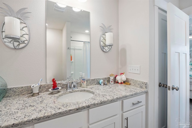 bathroom featuring vanity and curtained shower