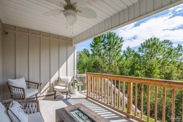 wooden balcony featuring a deck and ceiling fan