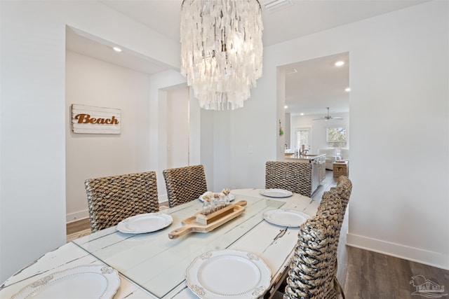 dining room featuring dark hardwood / wood-style floors and ceiling fan with notable chandelier