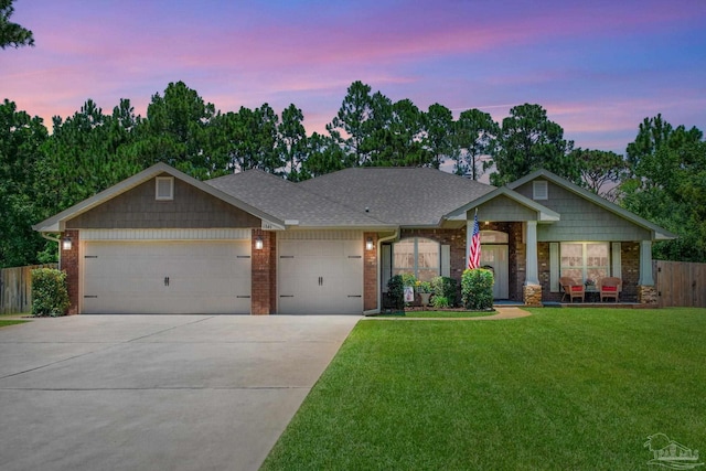 craftsman-style house with a garage and a lawn