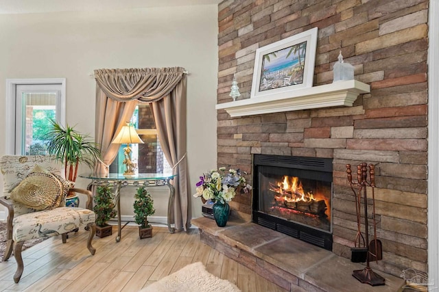 living area featuring a fireplace and hardwood / wood-style flooring