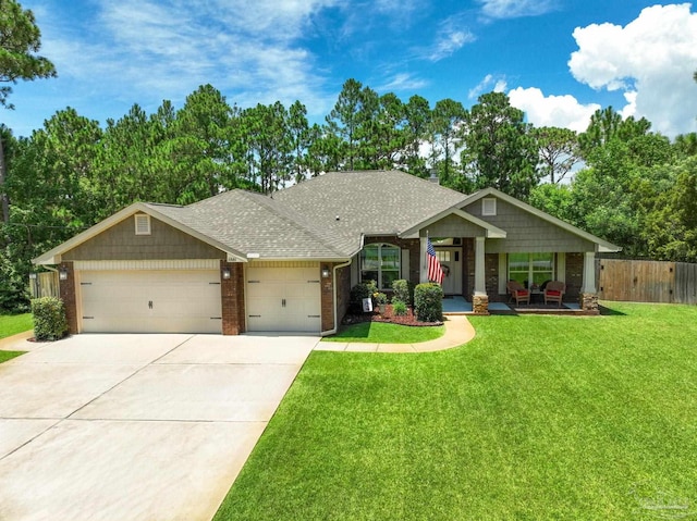 craftsman house with brick siding, a shingled roof, concrete driveway, an attached garage, and a front yard