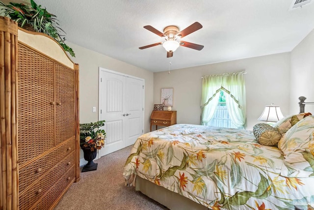 carpeted bedroom featuring a closet and ceiling fan