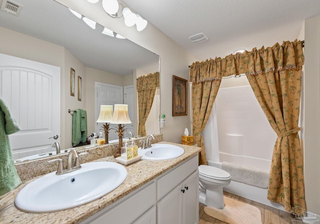 full bathroom with shower / tub combo with curtain, toilet, and double vanity