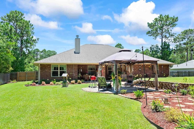 rear view of property with a patio area and a lawn