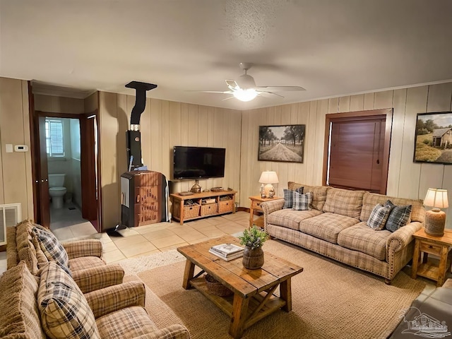 tiled living room with ceiling fan