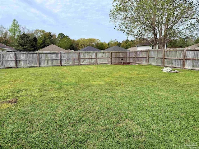 view of yard with a fenced backyard