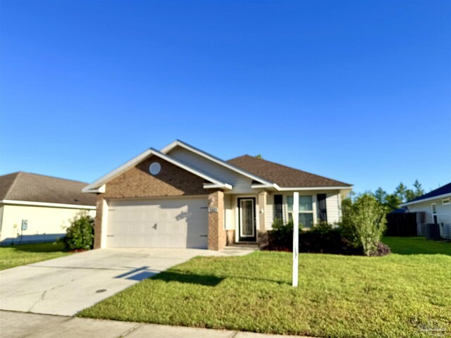 ranch-style house featuring an attached garage, driveway, a front yard, and cooling unit