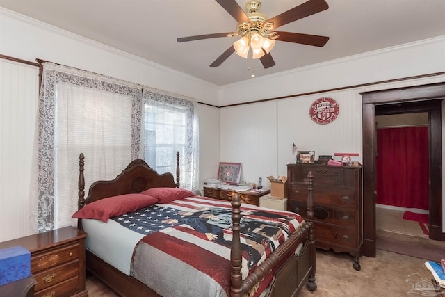 carpeted bedroom with ornamental molding and ceiling fan