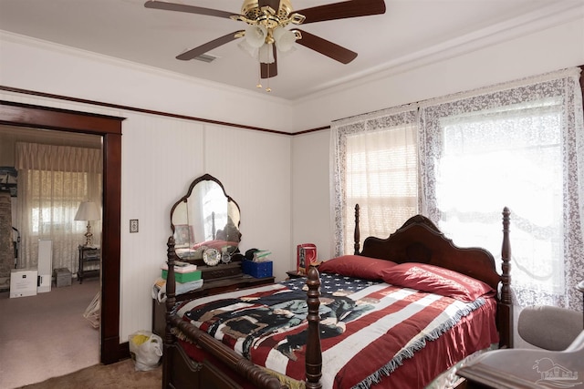 bedroom featuring carpet flooring, crown molding, and a ceiling fan