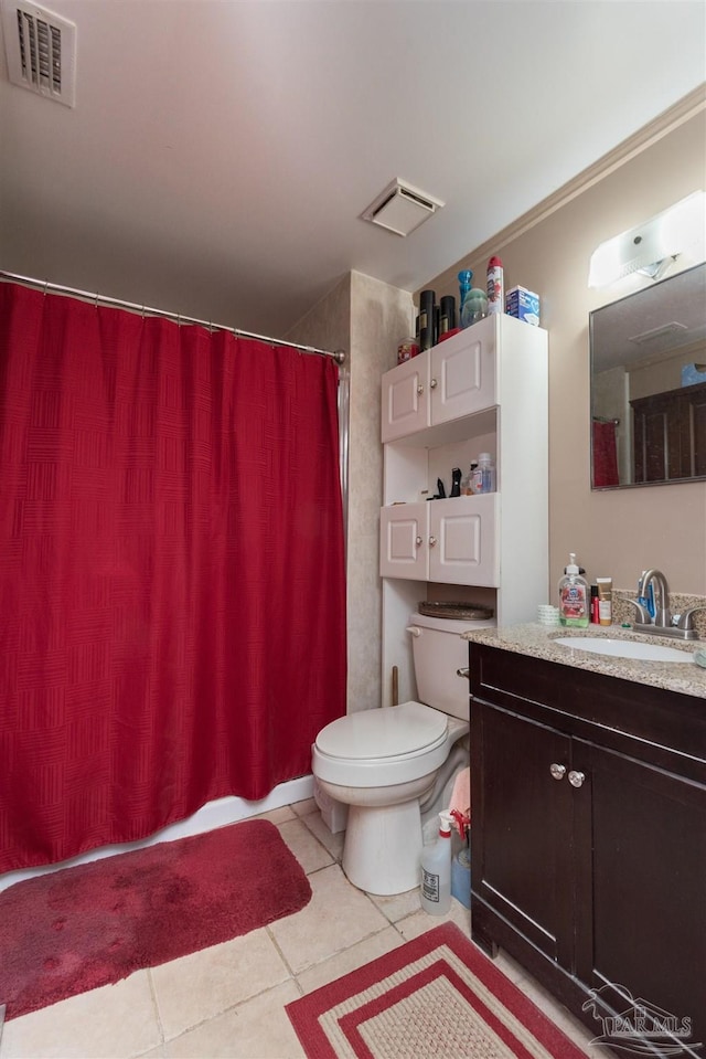 bathroom with toilet, tile patterned flooring, vanity, and curtained shower