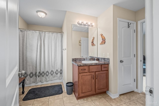 bathroom featuring walk in shower, tile patterned flooring, and vanity