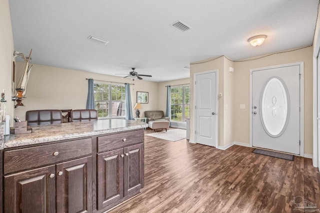 kitchen featuring ceiling fan, dark hardwood / wood-style floors, dark brown cabinetry, and a textured ceiling